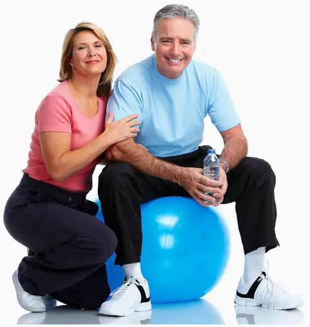 A man and woman sitting on top of an exercise ball.